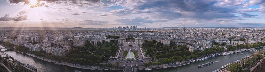 A panoramic sunset view of Paris, centered on the Jardins de Trocadero and Palais de Chaillot, with the Seine River in the foreground, taken from atop the Eiffel Tower.