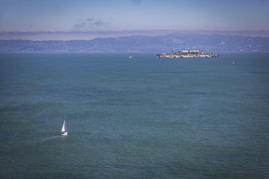 View of Alcatraz Island from the Golden Gate Bridge, showcasing San Francisco Bay's iconic scenery.