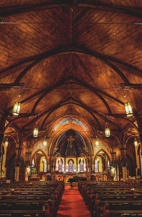 St. John's Anglican Church showcases stunning wooden architecture and intricate stained glass, capturing the heritage of Lunenburg, Nova Scotia.