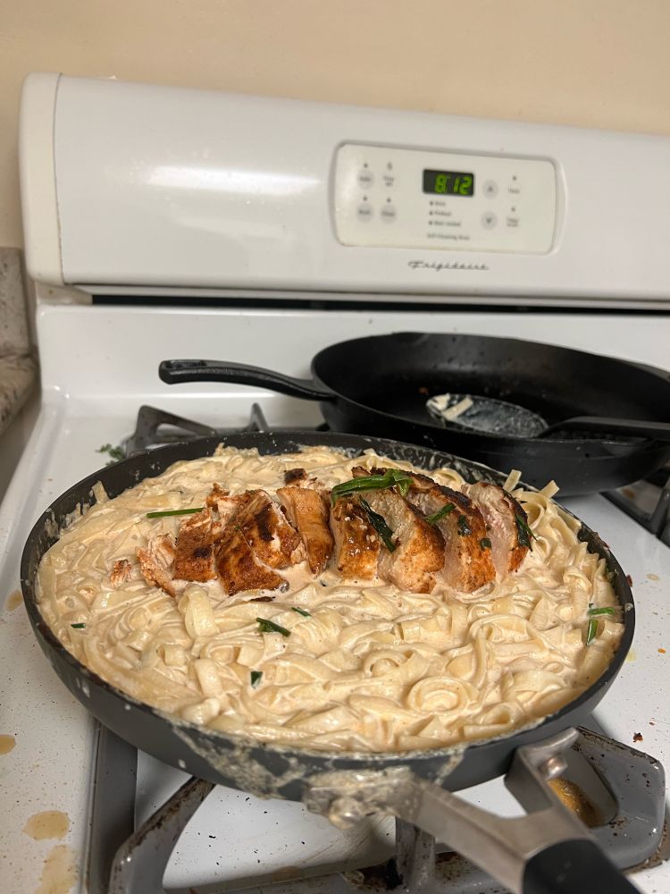 Chicken Alfredo cooked on stovetop 