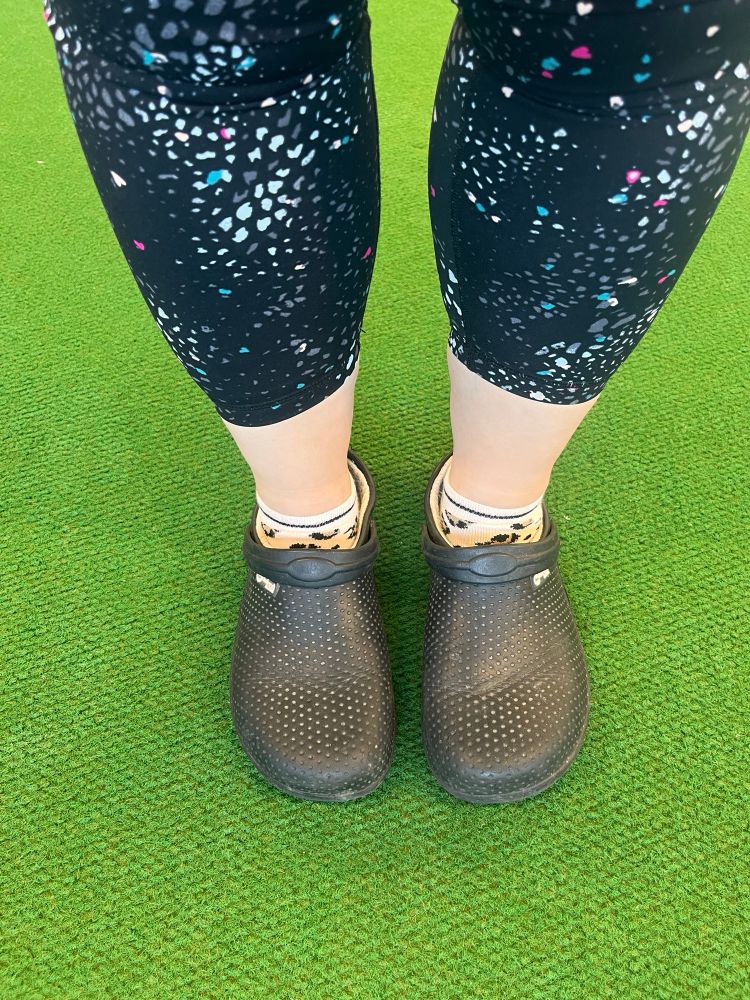 My legs and feet on the gym green carpet. Wearing fake Crocs. 