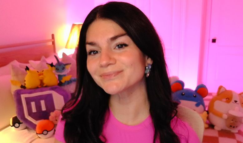 Dark haired girl on pink backdrop in pink shirt 
