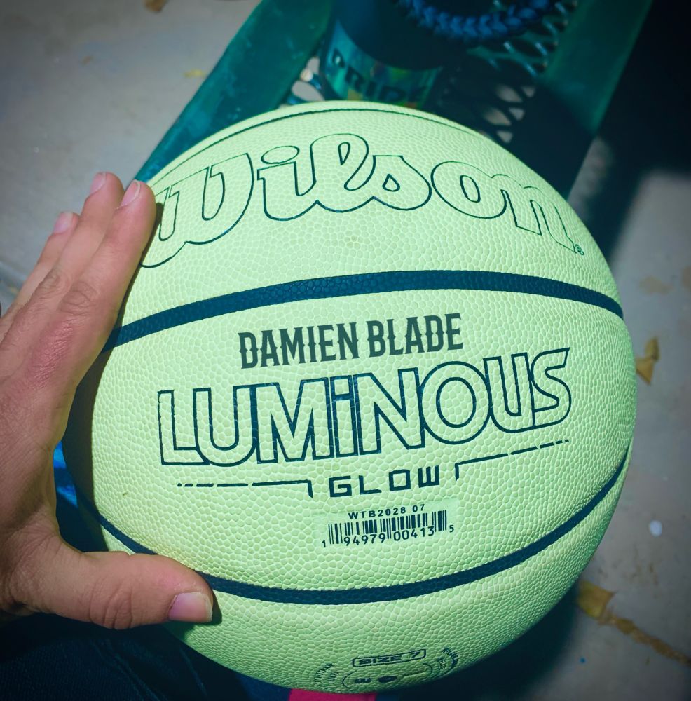 A glow in the dark basketball being held by Damien Blade (he/him) a NSFW content creator who has a dope OnlyFans & JustForFans under the name damienbladensfw 