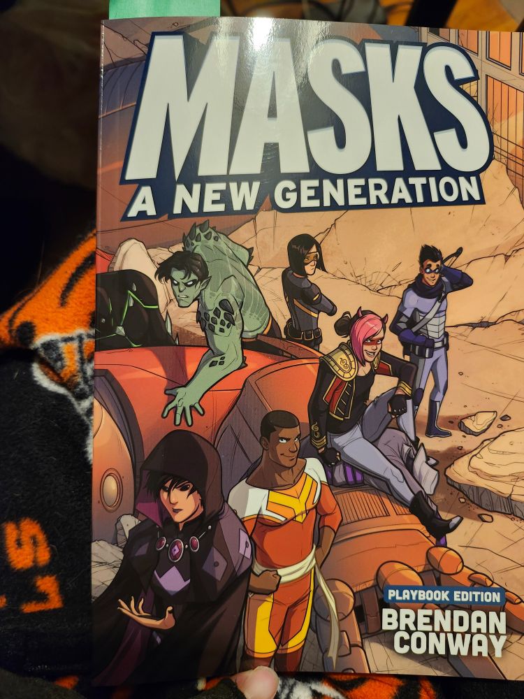 Masks: A New Generation, a ttrpg book covered with costumed young heroes who look vaguely like trademarked comic characters 