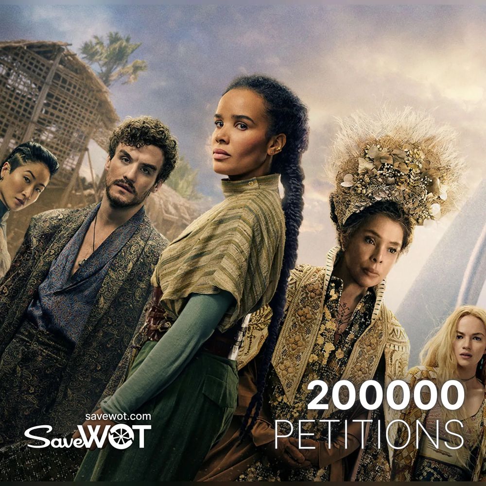 Promotional image for The Wheel of Time featuring five central characters standing in front of traditional wooden structures under a dusky sky. At the center is Zoë Robins as Nynaeve, wearing layered green and gold robes with a long braid down her back, looking determined. To her right is Sophie Okonedo as Siuan in an ornate gold-embroidered gown and an elaborate feathered headdress. Ceara Coveney as Elayne stands on the far right in a golden outfit with flowing blonde hair. On the left, Kae Alexander as Min appears in a patterned vest and deep green sleeves, and Donal Finn as Mat wears a brocade jacket with a slightly disheveled look. Overlay text reads “200000 Petitions” and “SaveWOT savewot.com”.