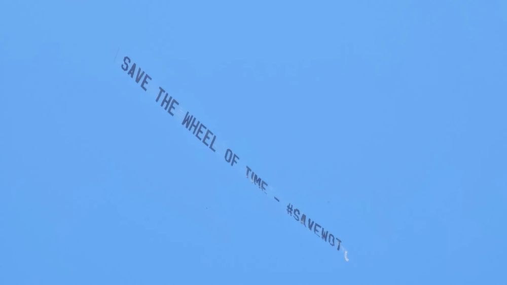 Sky banner against a blue sky that reads: Save The Wheel of Time - #SAVEWOT 