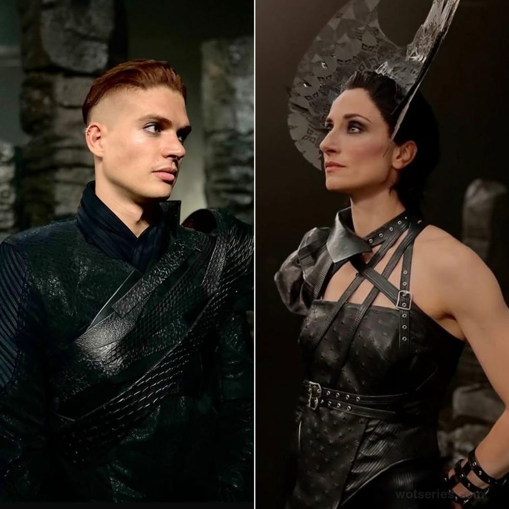 A split-image from The Wheel of Time featuring Rand al'Thor (Josha Stradowski) and Lanfear (Natasha O'Keeffe) in a scene from Moiraine's trip through the rings. On the left, Rand wears a black, textured leather outfit with layered straps crossing his chest. His reddish-brown hair is slicked back, and he gazes off to the side with a contemplative expression. The dimly lit stone setting adds an ominous tone. On the right, Lanfear dons an intricate black leather ensemble with multiple straps and metallic embellishments. She also has a dramatic jagged headpiece on.