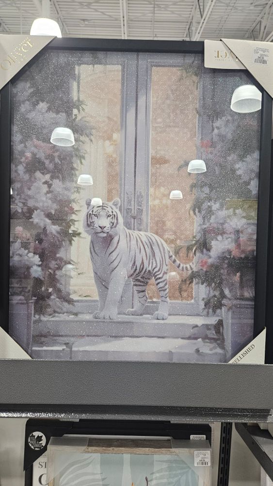 A canvas print of a white tiger on a front porch with double opening balcony glass doors. 

The tiger is framed by decorative trees in a wintery style