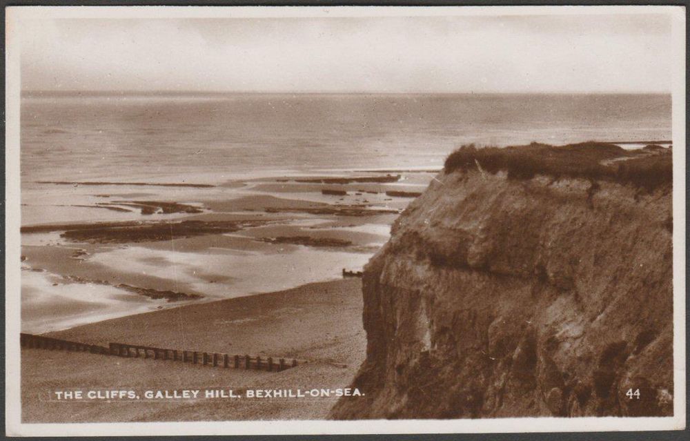 Sepia real photographic postcard showing a view of the cliffs at Galley Hill at Bexhill-on-Sea in Sussex.

Published by Excel Series, No 44.

Postally used on 21 July 1948 or 1953 with Bexhill-on-Sea cancellation on orange 2d stamp and sent to Mr & Mrs A.J. Balcombe, 2 Prospect Place, Burwash, Etchingham, Sussex.

Good condition, with very slight corner bumps, but a few light impressions to front where a photo has been stored on top.