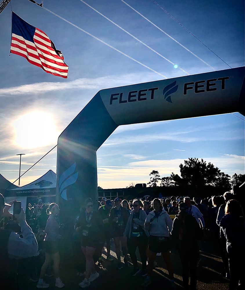 Sunrise, the American flag and runners. Moving in one direction. United. 
