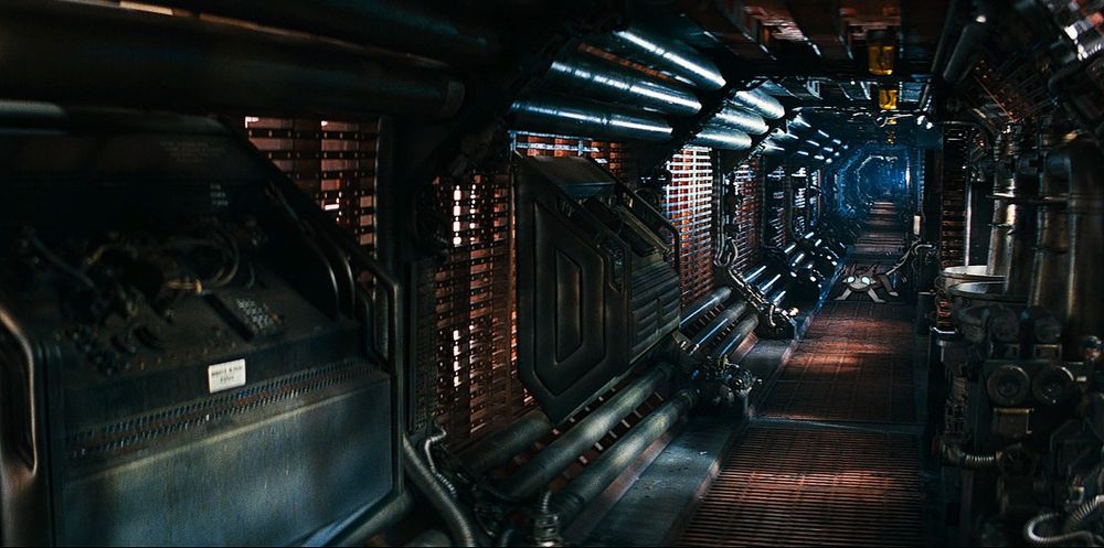 Screenshot from a spaceship hallway from Alien, 1979.
A tiny chibi doodle of my oc Diss is seen shaking on four legs far into the background