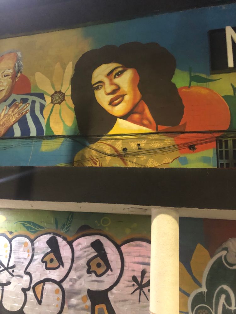 A mural of a 1940s styled woman with long dark hair