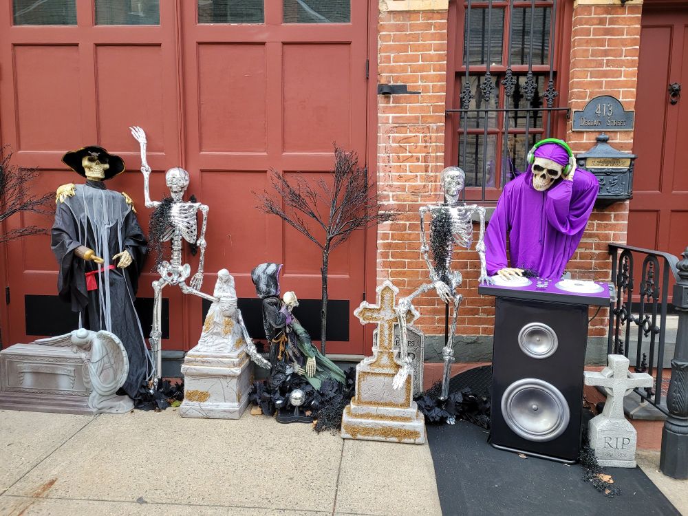 A Halloween display with skeletons dancing to a skeleton DJ 