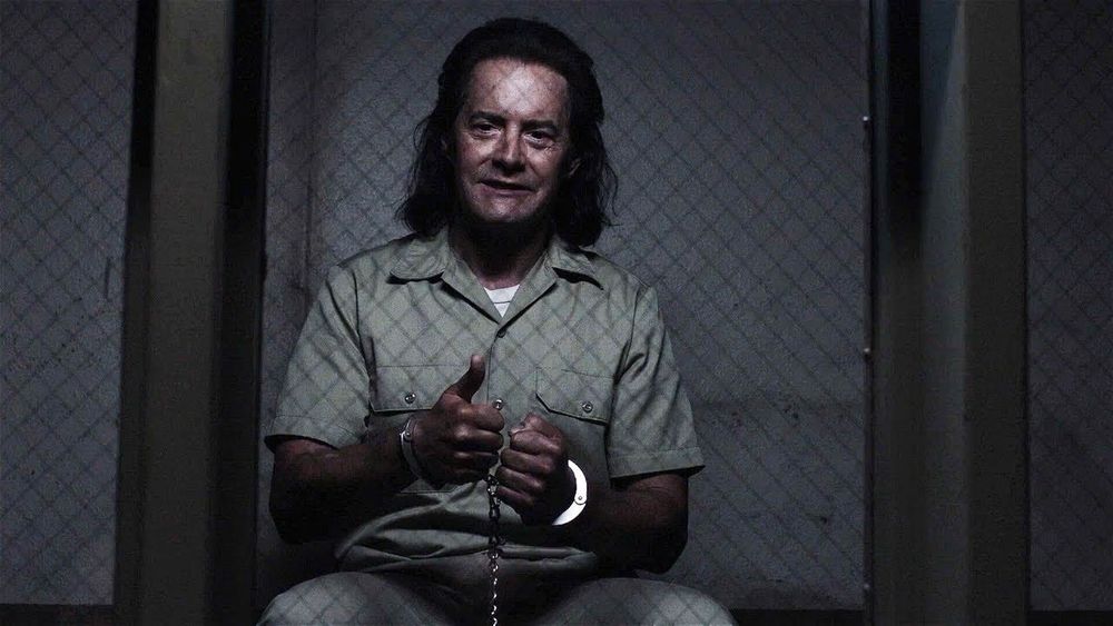 Dark Coop gives a creepy thumbs up from jail