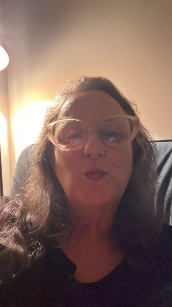 Eu sentada no sofá, mandando um beijo pra tu