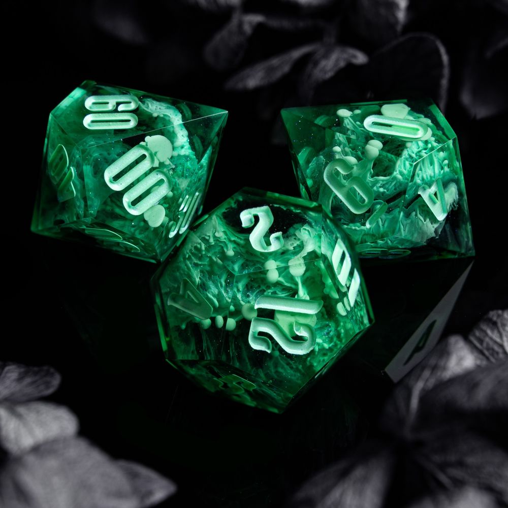 A ghostly green set on black background surrounded by gray flowers. The dice have detailed texture with pretty tendrils.

This picture features the D10, D12 and D100