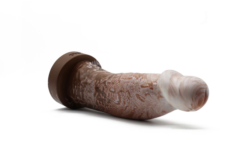 Diedrich the realistic dildo laying on its side, angled to show the wide g-spot/prostate-rubbing flare of its head. 