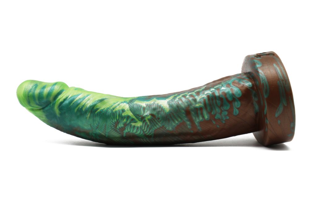 A large, slender realistic dildo with a narrow head, a curved shaft, and a flared base. It's pigmented with a mix of green shades and a dark skin tone.