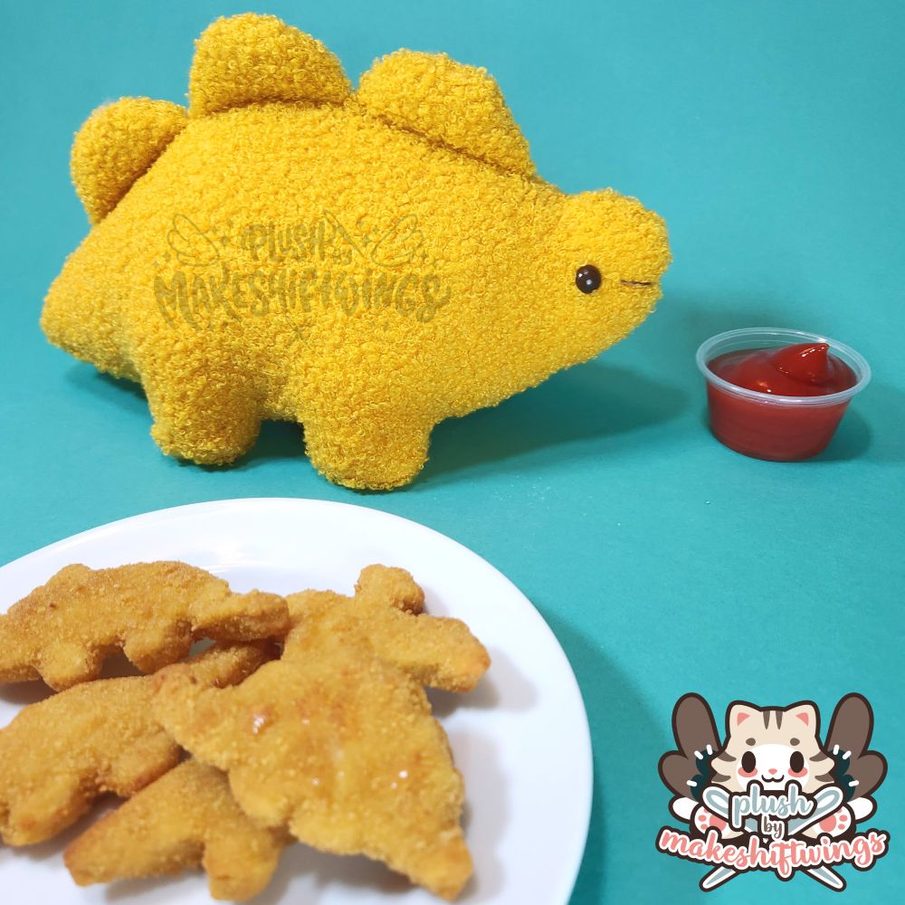A picture of the stegosaurus dino nuggie plush (pattern by me) with a plate of delicious dino nuggies.
