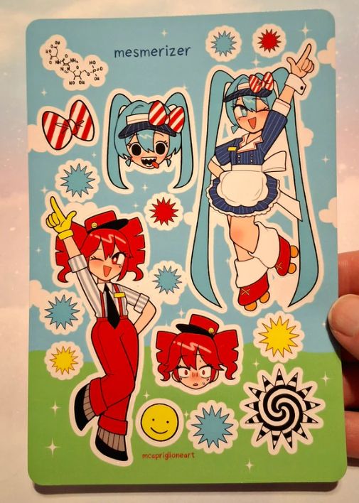 photo of a hand holding a sticker sheet designed after the mesmerizer miku and teto music video