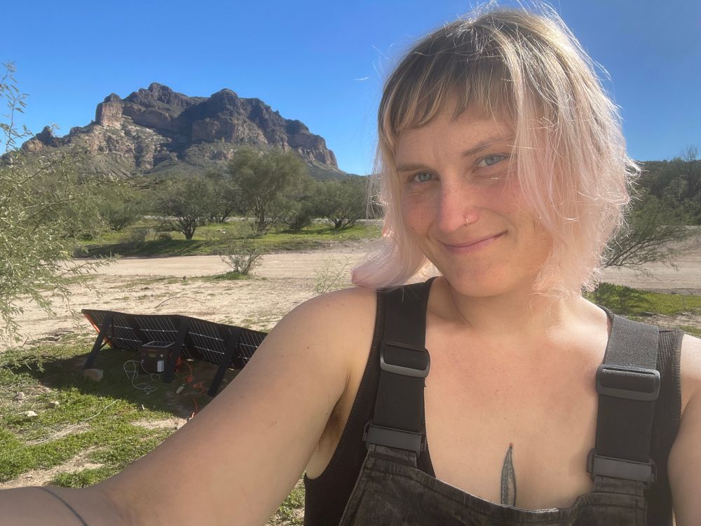 me, in overalls, standing in front of picketpost mountain in arizona