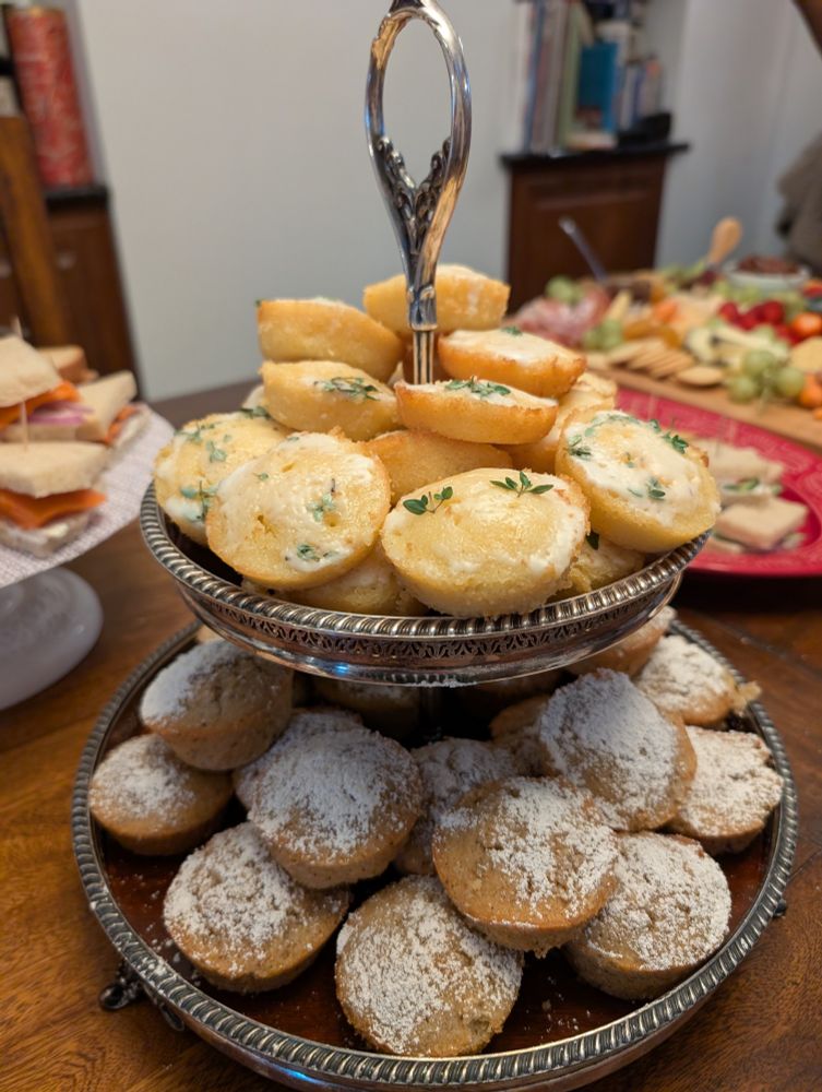 a two-tiered tray piled high with tiny cakes