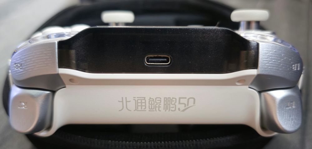 Shot of the top of the controller, showing the USB Type C connection, silver shoulder buttons and triggers, and the logomark of the controller