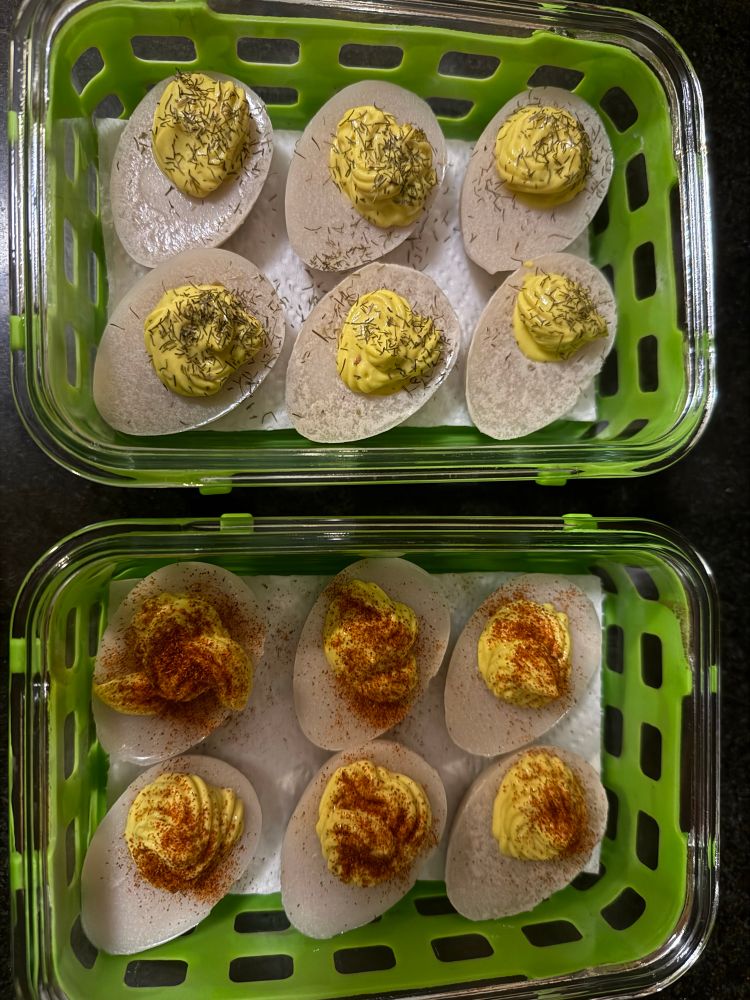 two containers of 6 deviled eggs each, one topped with dill and one topped with paprika. 

very very similar in appearance, texture, and taste to the real thing!

appearance: half a hard boiled egg, cut lengthwise, into which a yellow yolk mix has been creamed and applied, topped with their respective toppings. 