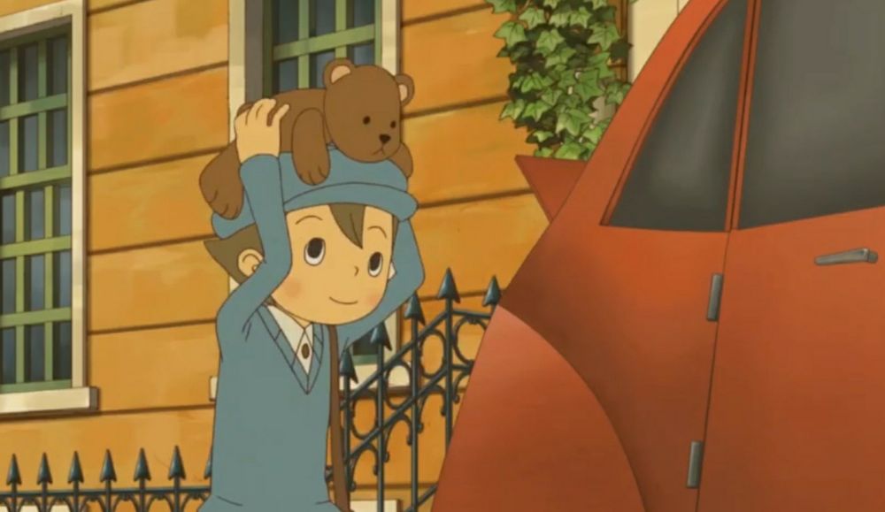 Luke carries a teddy bear on his hat and smiles