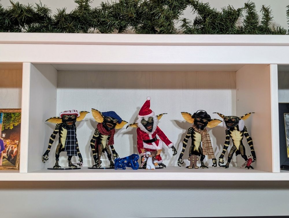 Gremlins and Gizmo dressed in winter clothing, including Stripe dressed as Santa Claus.