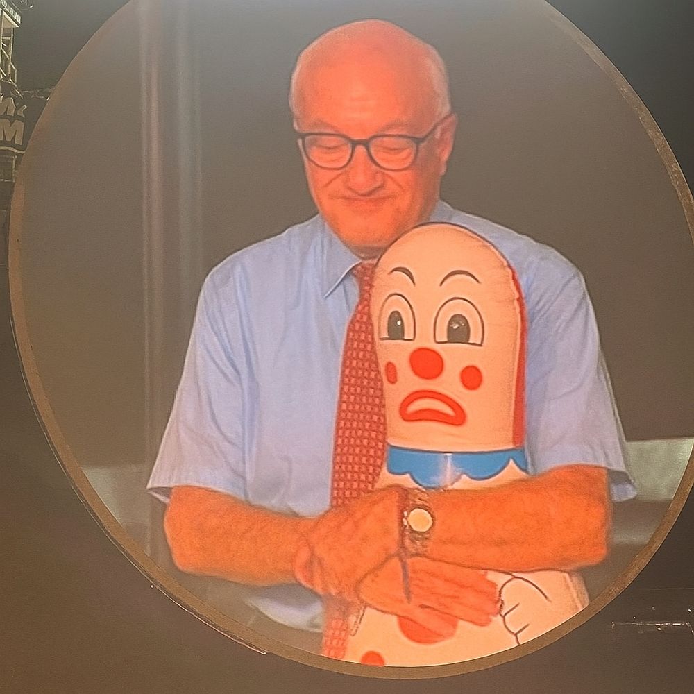 Albert Bandura on the jumbotron with a Bobo Doll.