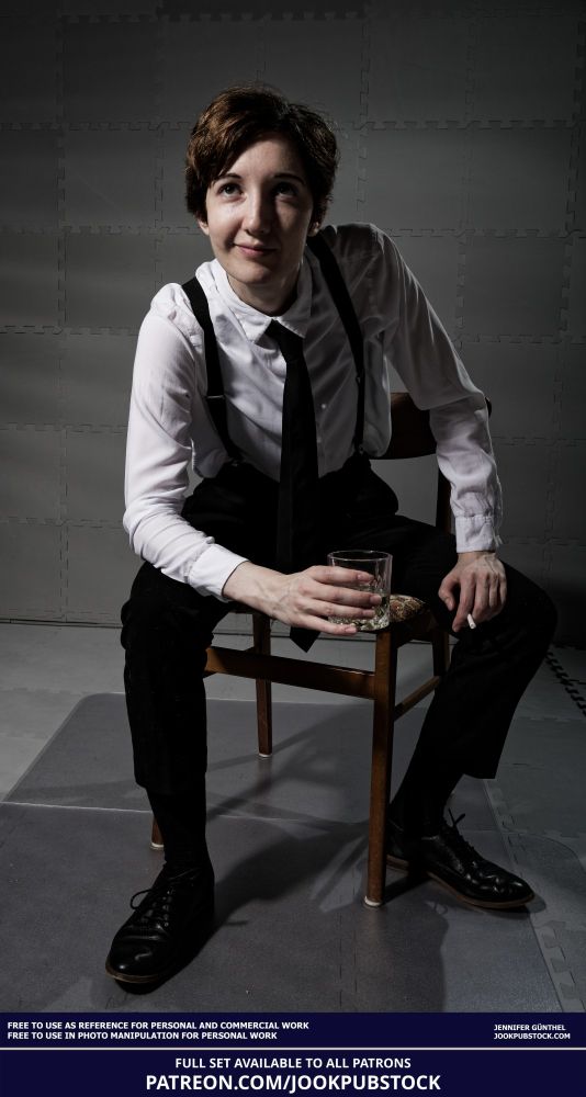 drawing reference photo of a model wearing a suit, sitting on a chair and holding a glass and a cigarette
