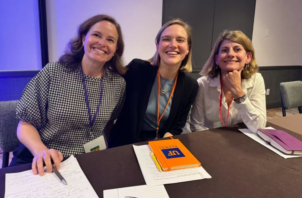 Smiling photo of three panelists seated at a table - Mary Hunter, Christy Slobogin, and Fiona Johnstone.