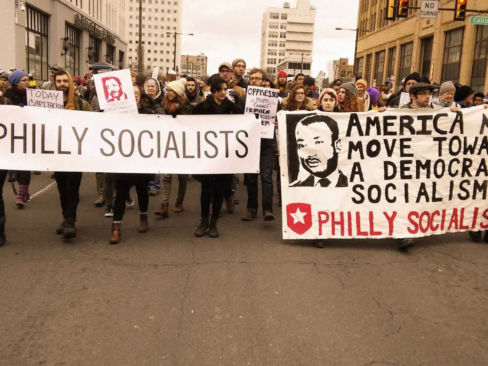 Philadelphia Socialists March.  Signs Say: "Philly Socialists" "America Needs to Move Towards a Democracy via Socialism ~ Philly Socialists"