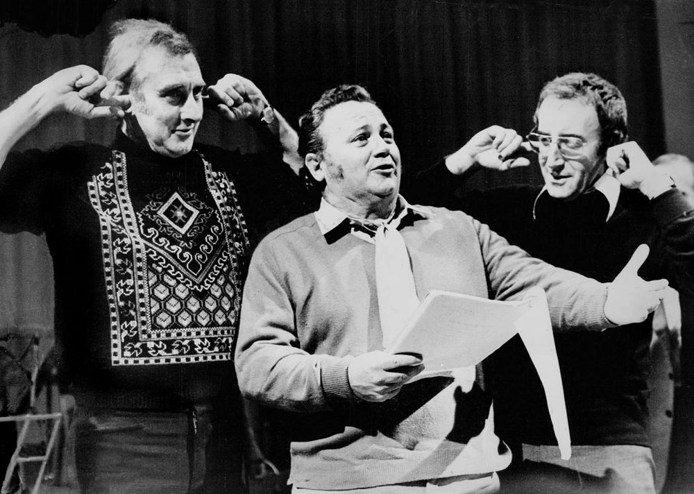 Picture of Harry Secombe singing; Spike Milligan and Peter Sellers with their fingers in their ears 