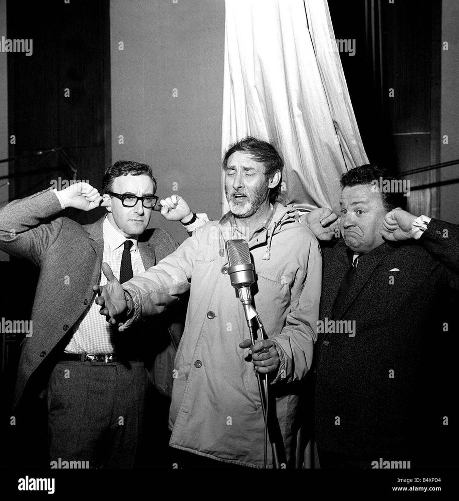 Picture of Spike Milligan singing; Peter Sellers and Harry Secombe with their fingers in their ears 