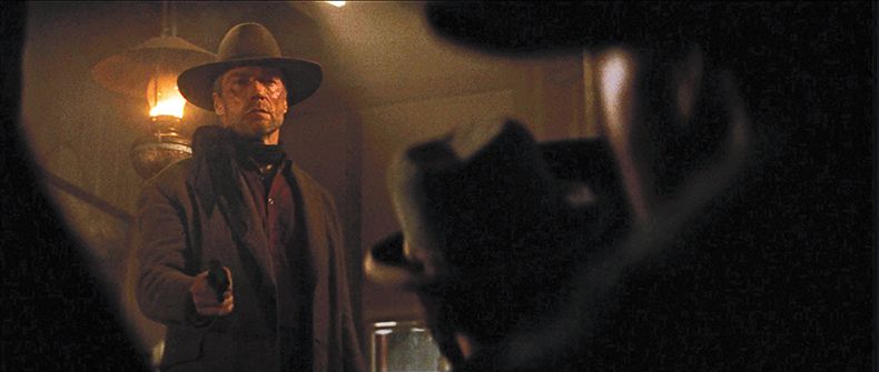 Clint Eastwood from Unforgiven facing the crowd in the bar with a pistol about to announce, "anyone doesn't wanna die better clear on out the back"