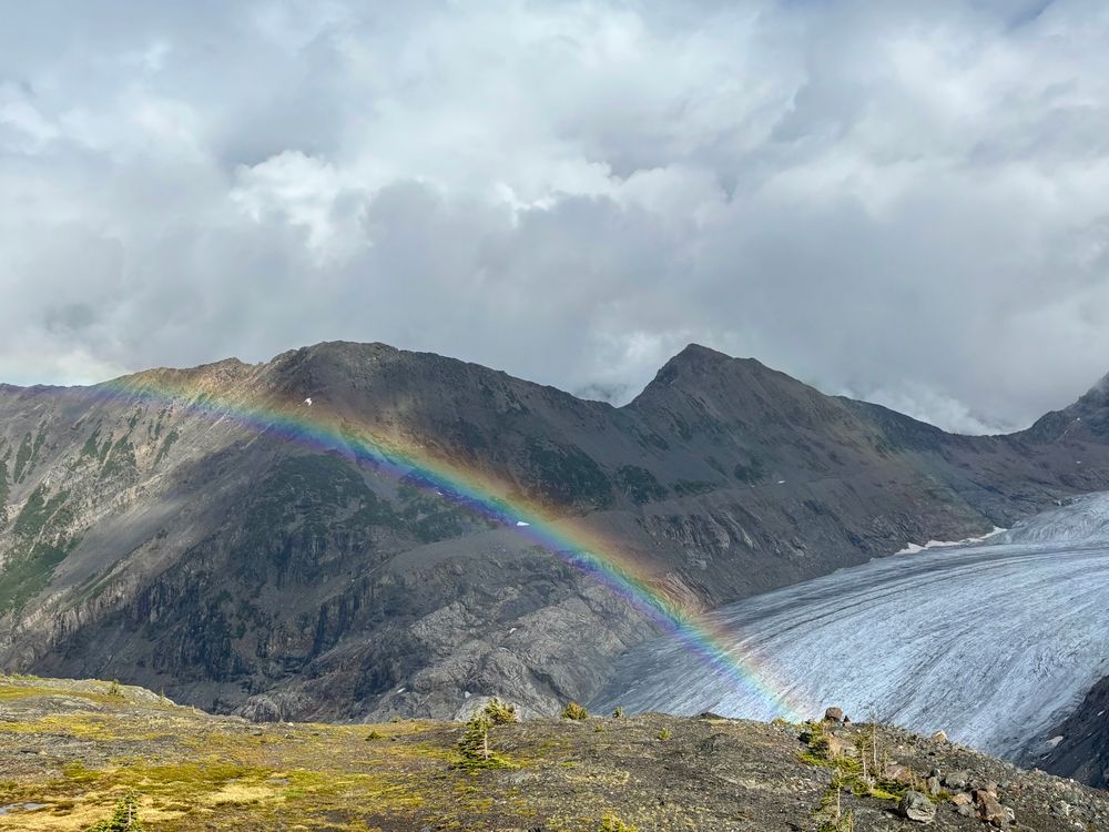 Rainbow over a glacier in the mountains 