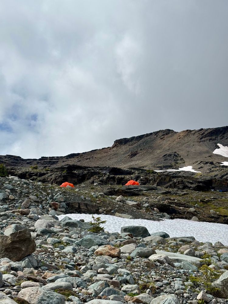 Two small orange tents in the alpine 