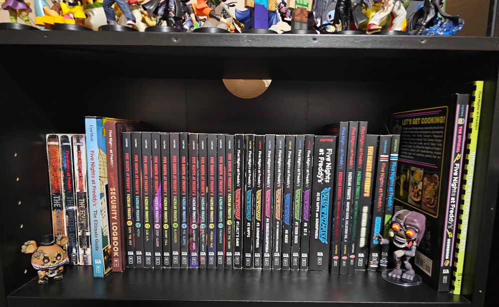 My collection of FNaF books, with Twisted Freddy and the Mimic here too. Any some of my amiibos