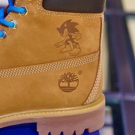 A close-up of some Sonic the Hedgehog-themed Timberlands showcasing the Timberlands logo and Sonic with a pair of Timbs on