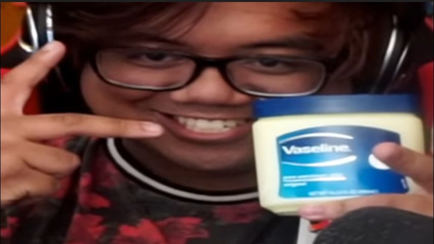 Content creator Acai holding a tub of Vaseline.