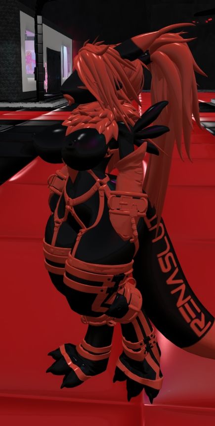 Viki Olsen, wearing her black and dark orange heavy rubber renatoy suit.