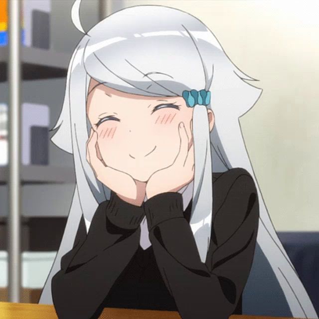 a girl with long white hair is sitting at a table with her hands on her face