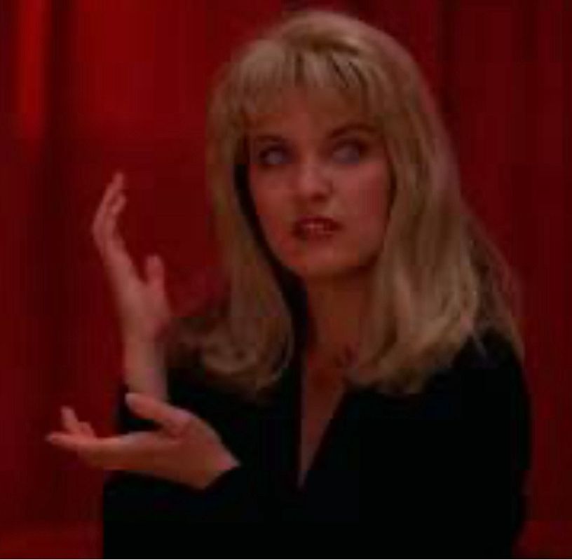 Laura Palmer doppelgänger posting her hands as if to say “meanwhile”