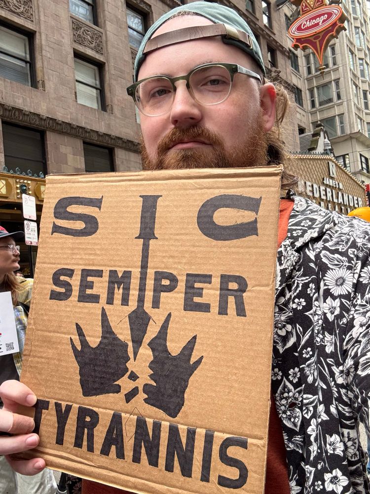 Me holding a Sic Semper Tyrannis poster with a spear breaking a crown.