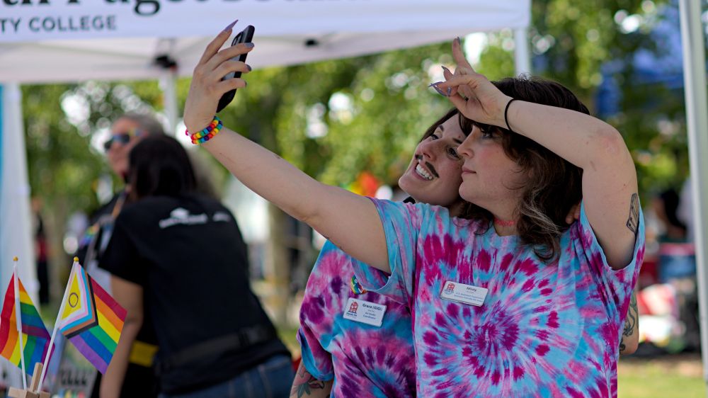 Two people from Hands on musuem posing for a selfie together, smiling 