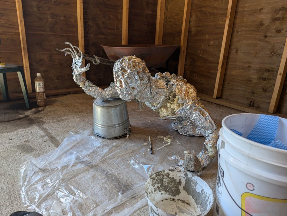 The same tinfoil and wire figure after I started to fill part of him up with spray foam to make him more sturdy