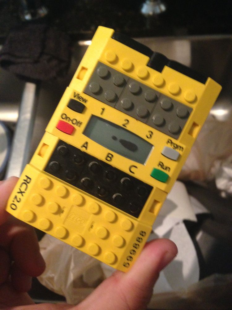 a lego mindstorms RCX 2.0, with the LCD screen showing a black leak