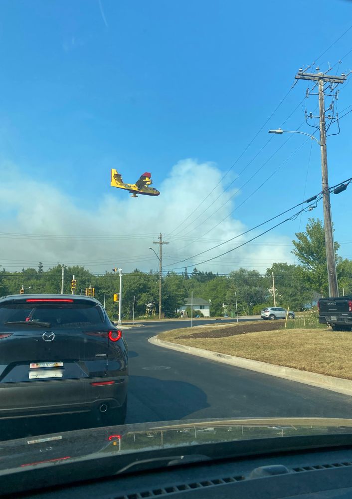 Intersection of Timberlea Parkway and St Margaret’s Bay Road with a low flying waterbomber plane.